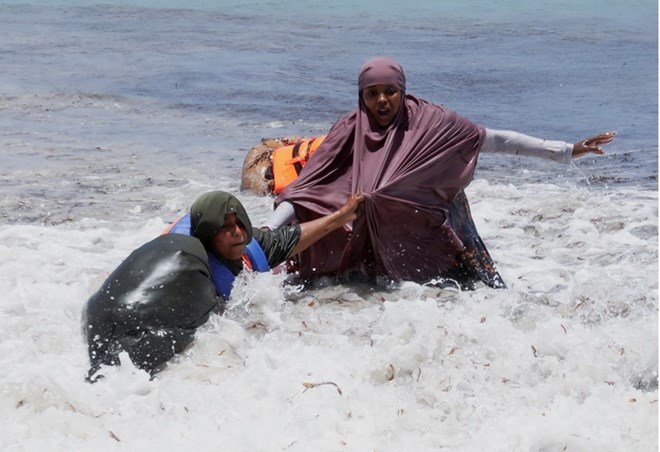 Revellers play during high waves in the Indian Ocean waters at the Liido beach in Mogadishu
